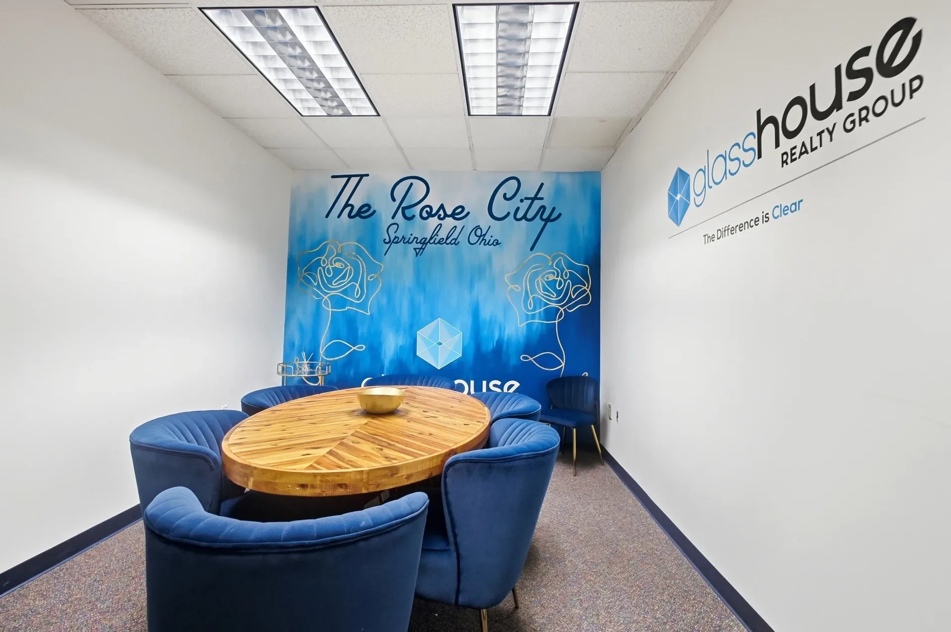 The Glasshouse Realty Group office lobby, with the glasshouse REALTY GROUP brand sign and The Difference is Clear. slogan