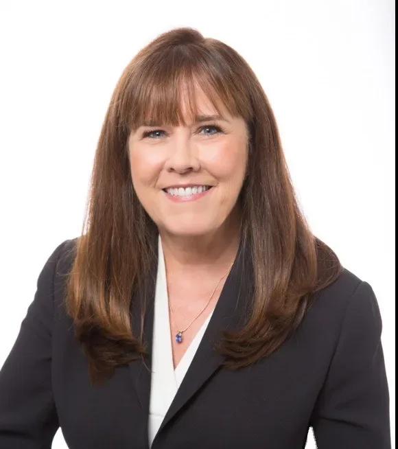 Professional headshot of Cindy Oja in a dark blazer