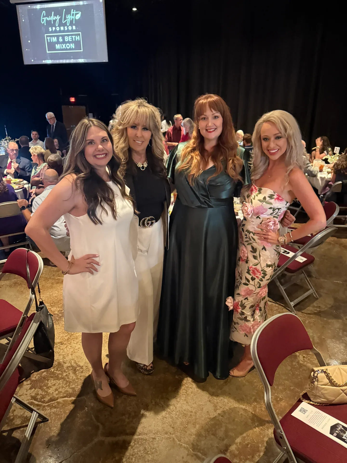 Lisa Copeland with women in formal attire at a gala event