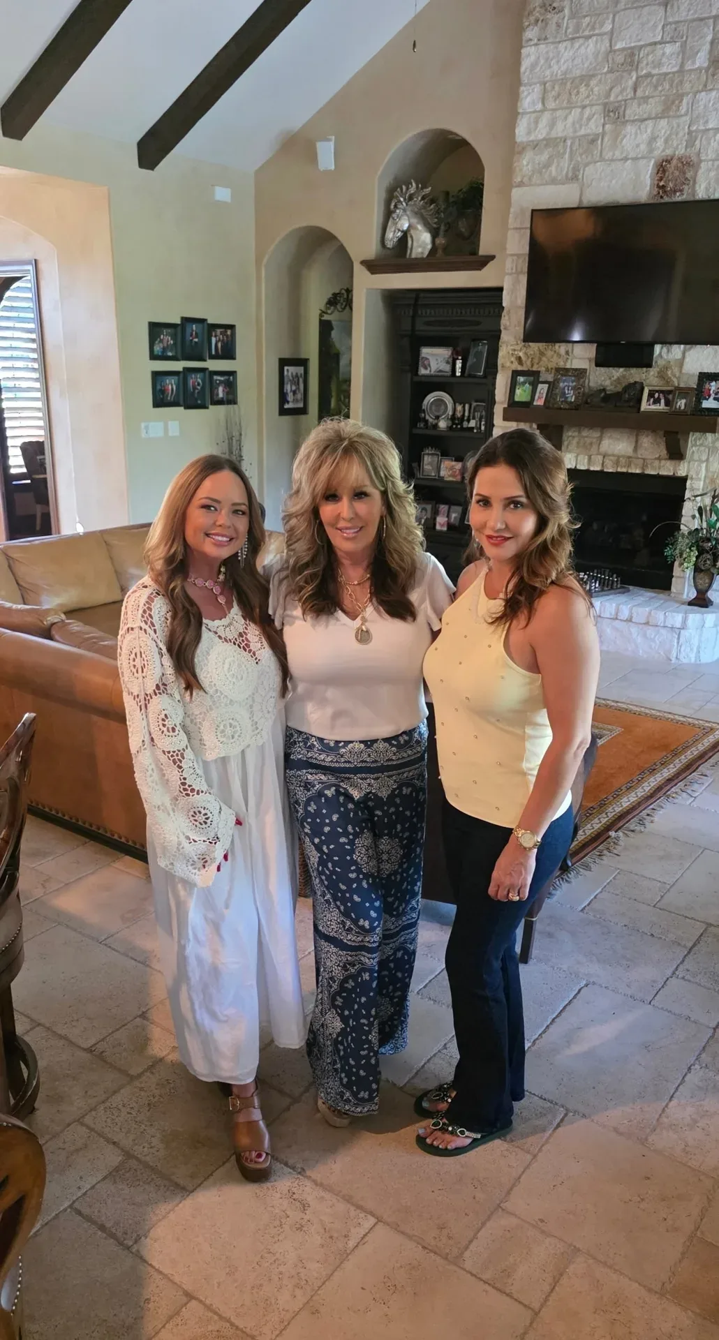 Lisa Copeland posing with two women in a residential living room setting