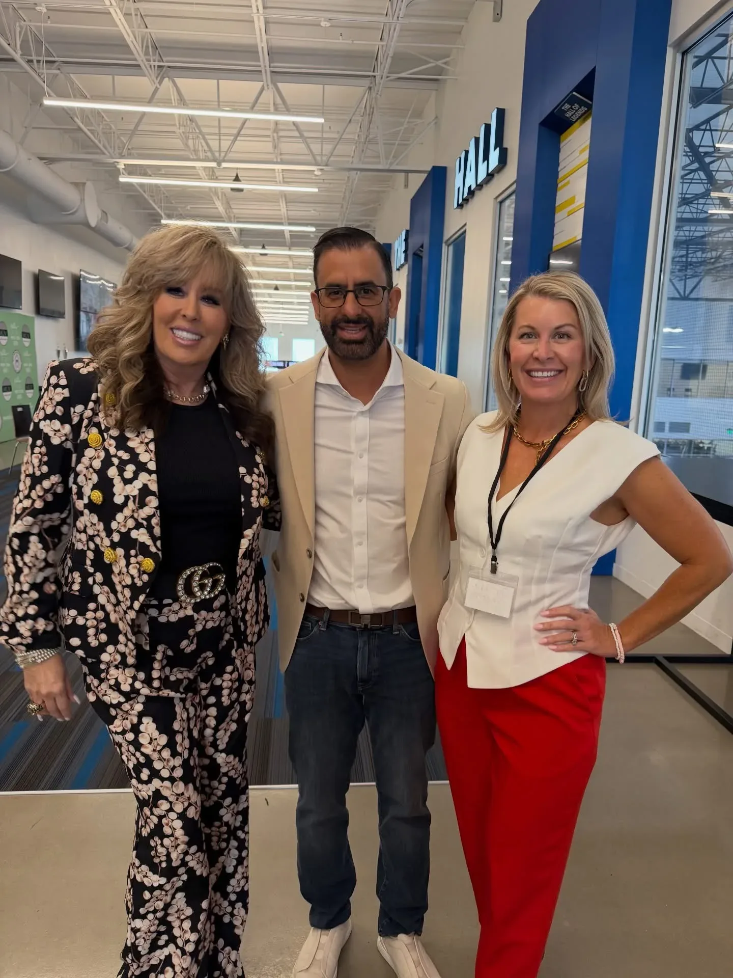 Lisa Copeland with two colleagues in a modern commercial hallway