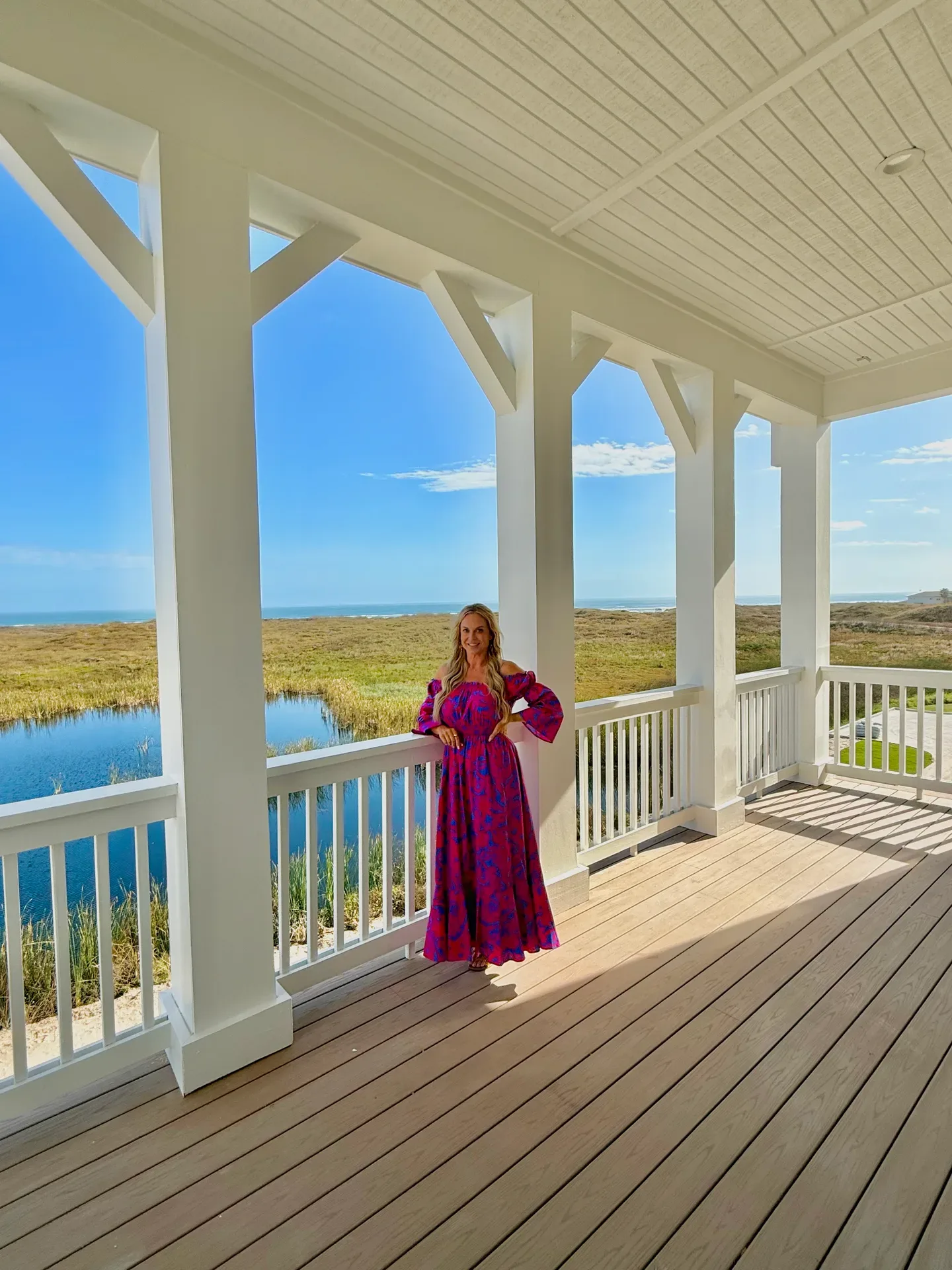 Emily Chemacki standing on a covered porch overlooking the Texas Coastal Bend