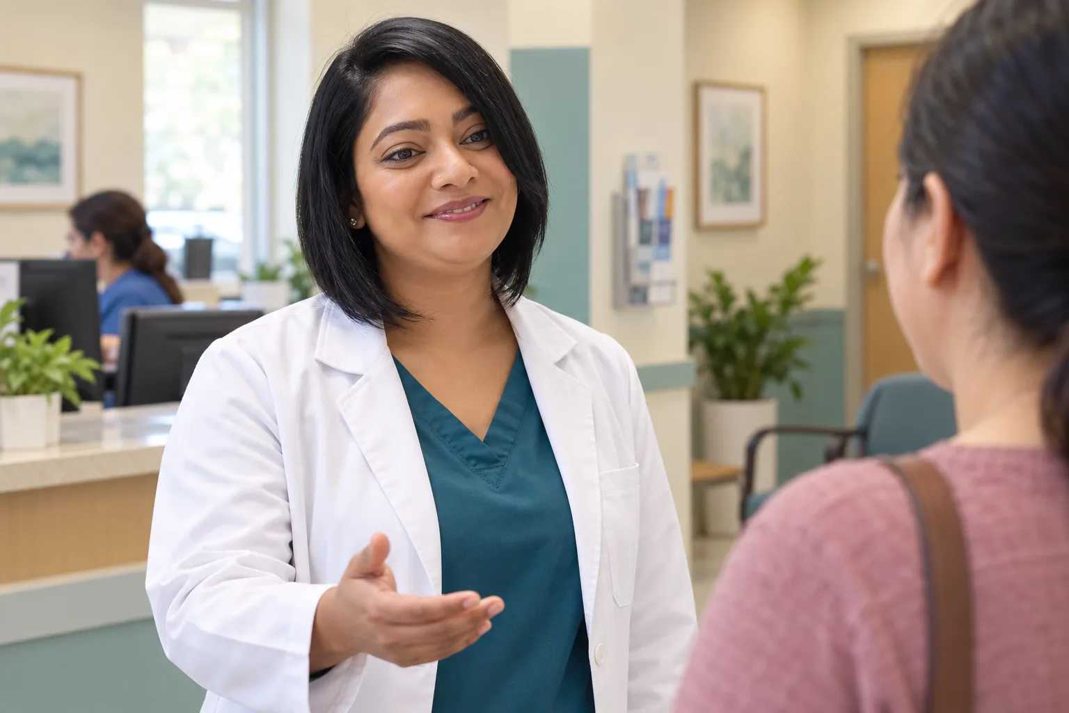 Provider welcoming a patient at reception