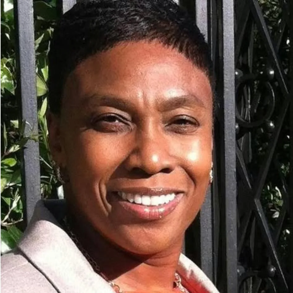 Denise Rush, REALTOR® with EXIT Realty Lowcountry Group, smiling warmly outdoors in a light blazer