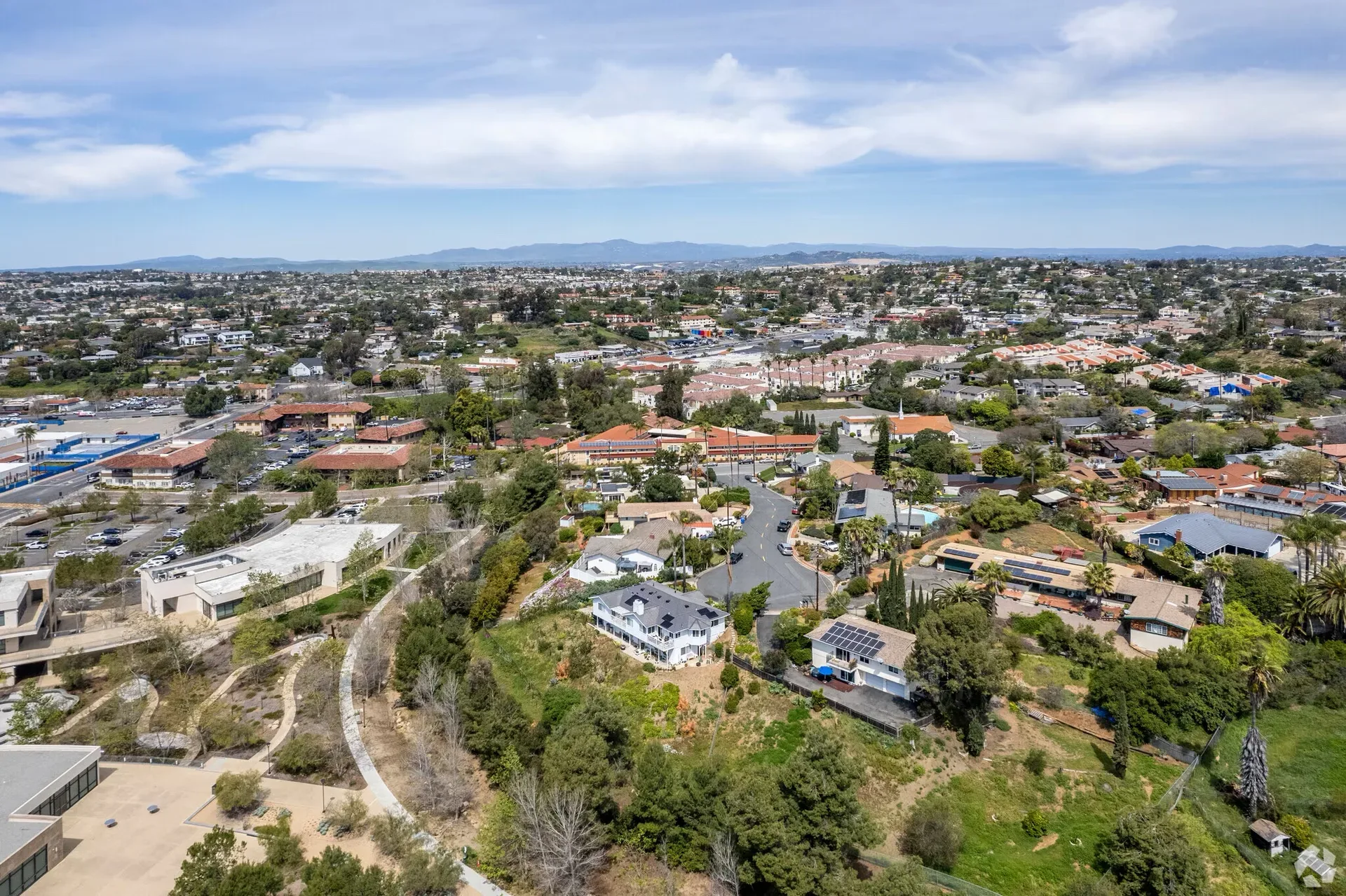 Aerial view of a suburban residential neighborhood with hills near Vista