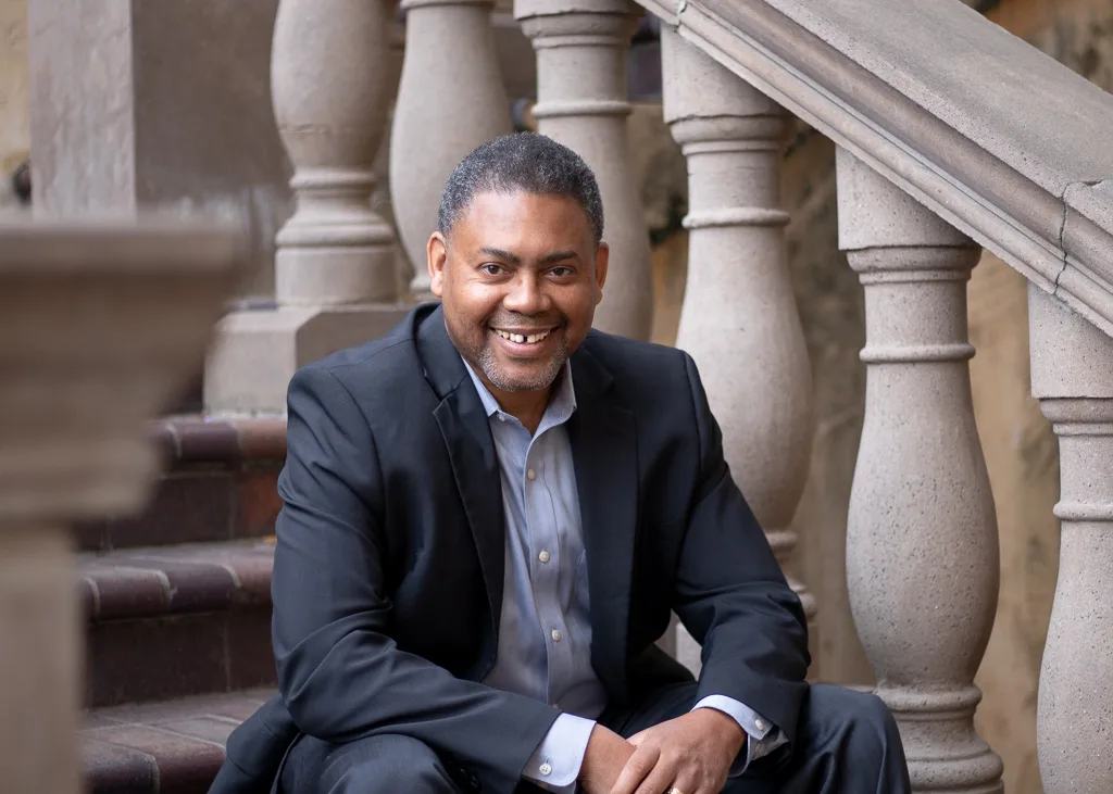 Garland Best, a smiling realtor in a dark suit