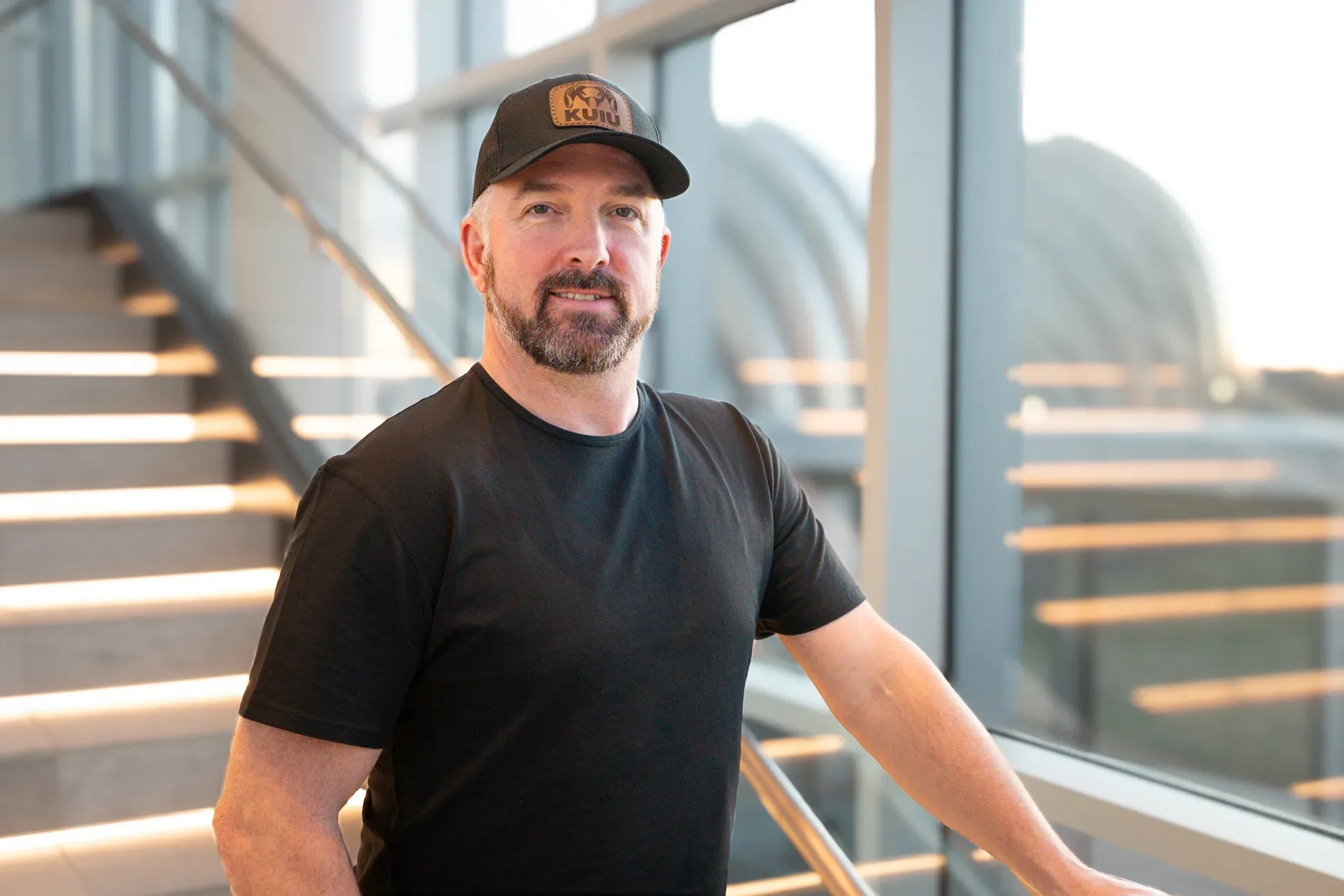 Josh Genz, broker and co-owner of United Country Midwest Lifestyle Properties, in a black t-shirt and dark baseball cap