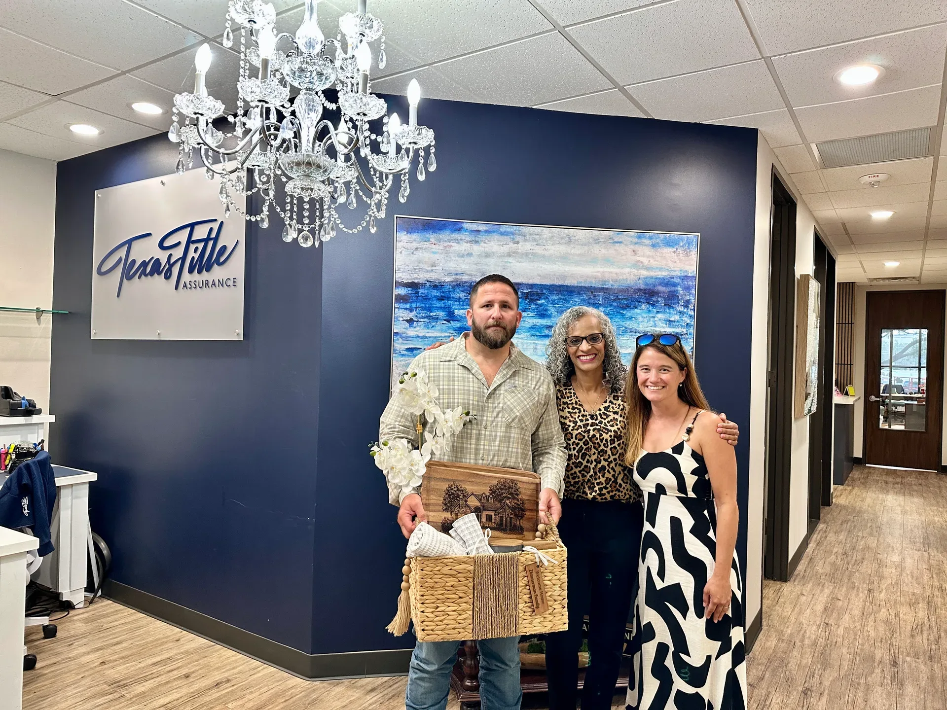 Tami Price with clients celebrating a closing at a title company office