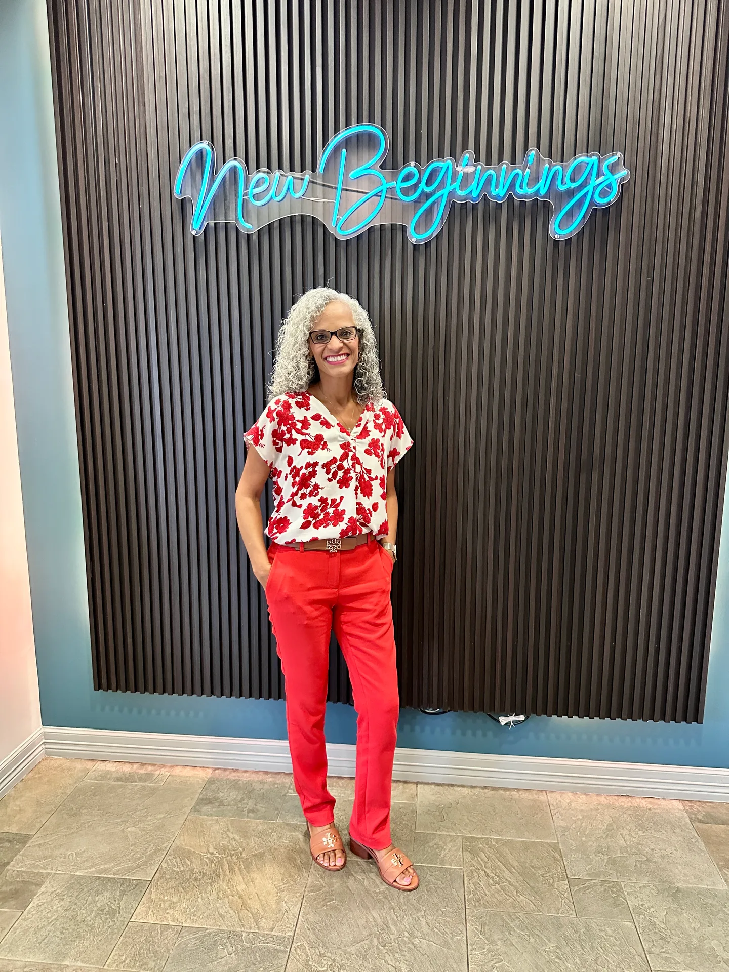 Tami Price standing in front of the New Beginnings sign at Tami Price Properties