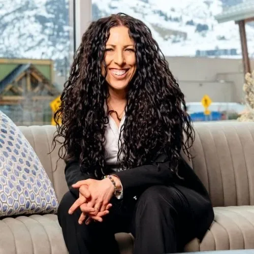 Belladonna Riso-Bayless, Associate Broker with eXp Realty's Luxury Division, smiling in her professional portrait