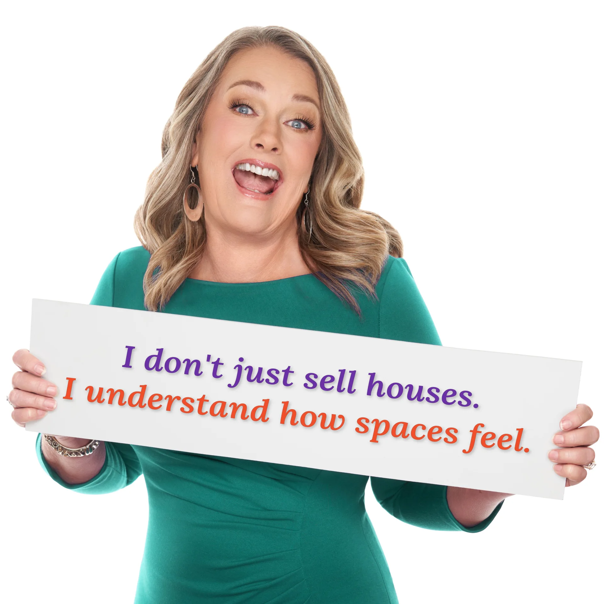 Deb Espinoza smiling while holding a sign with her personalized brand tagline