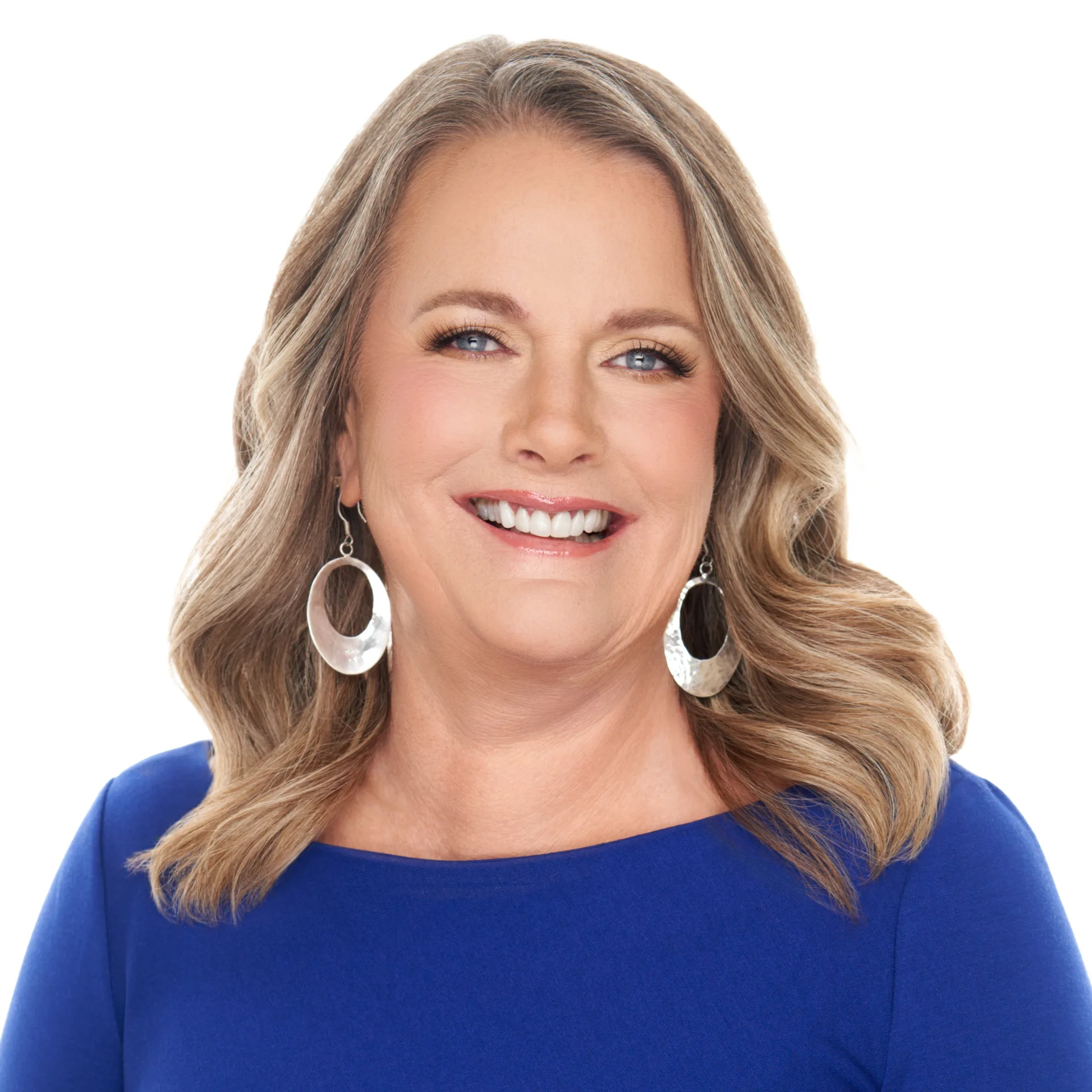Professional headshot of Deb Espinoza, a realtor with wavy blonde hair wearing a bright blue top