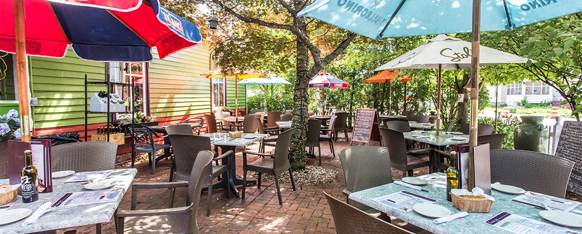 The Lucrecia patio with tables and colorful umbrellas