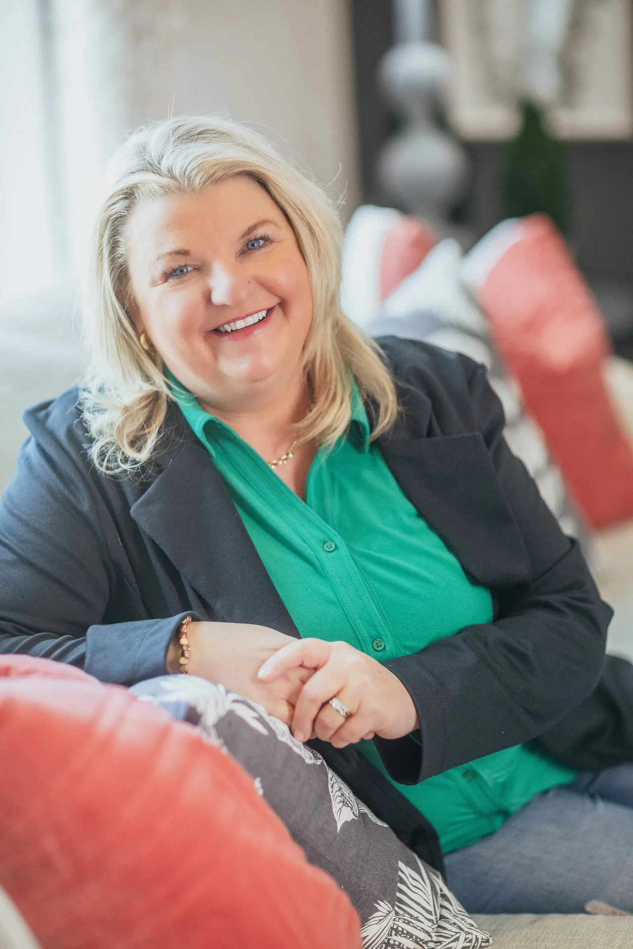 Professional headshot of Holly Brumm Furdo, a smiling woman with blonde hair in a navy blazer