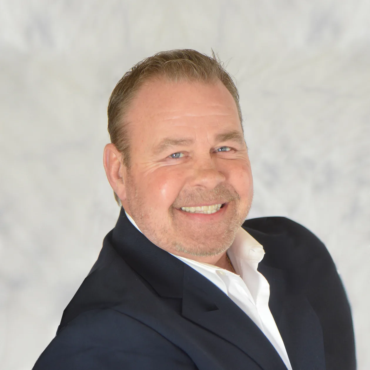 Professional headshot of Paul McMahon, real estate broker with eXp Realty
