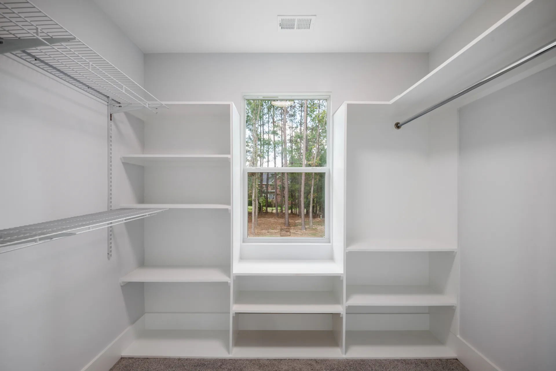 Walk-in closet with built-in shelving and natural light