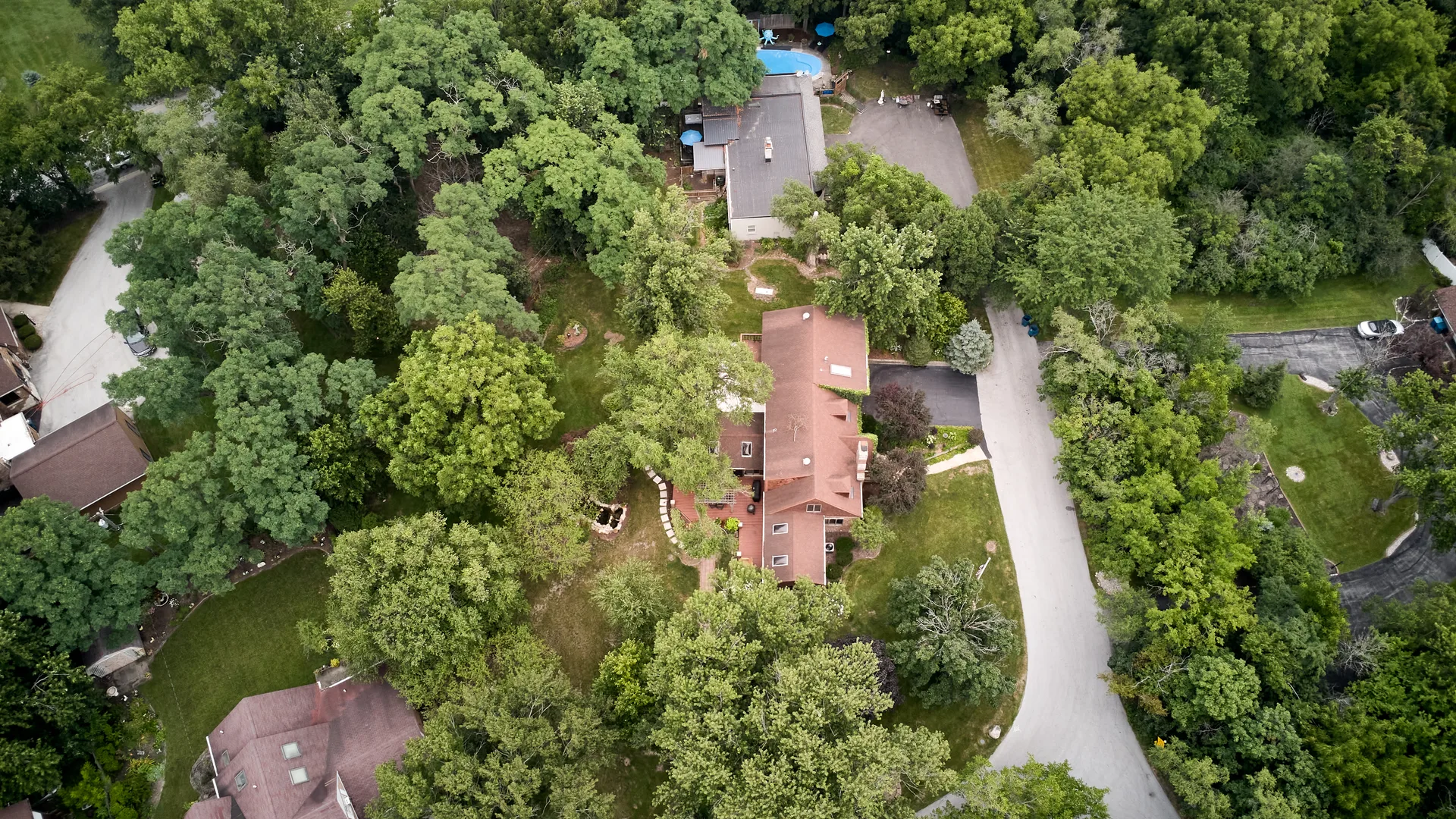 Aerial view of the house among extensive tree cover