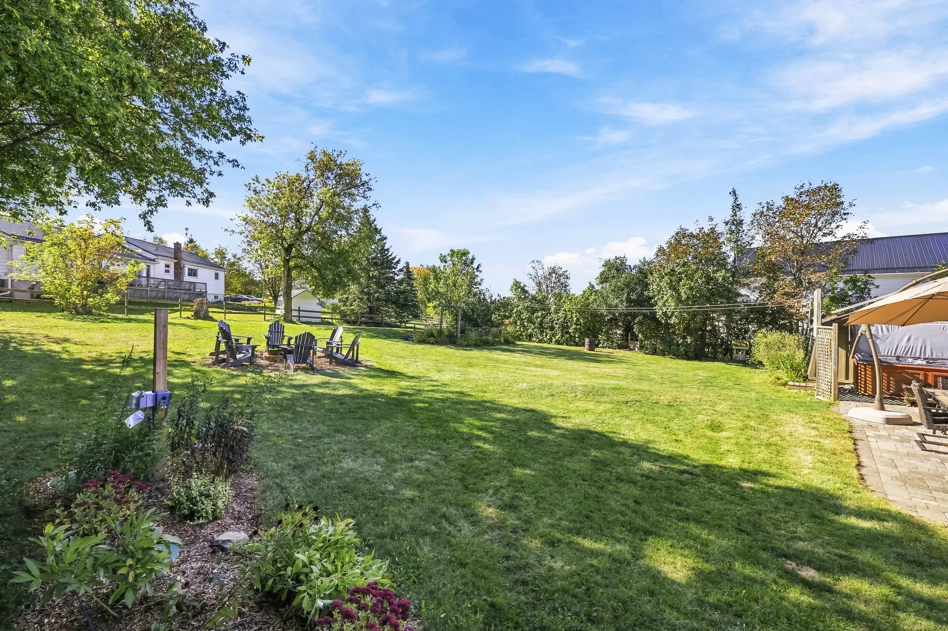Landscaped backyard with gardens, paved patio and established trees