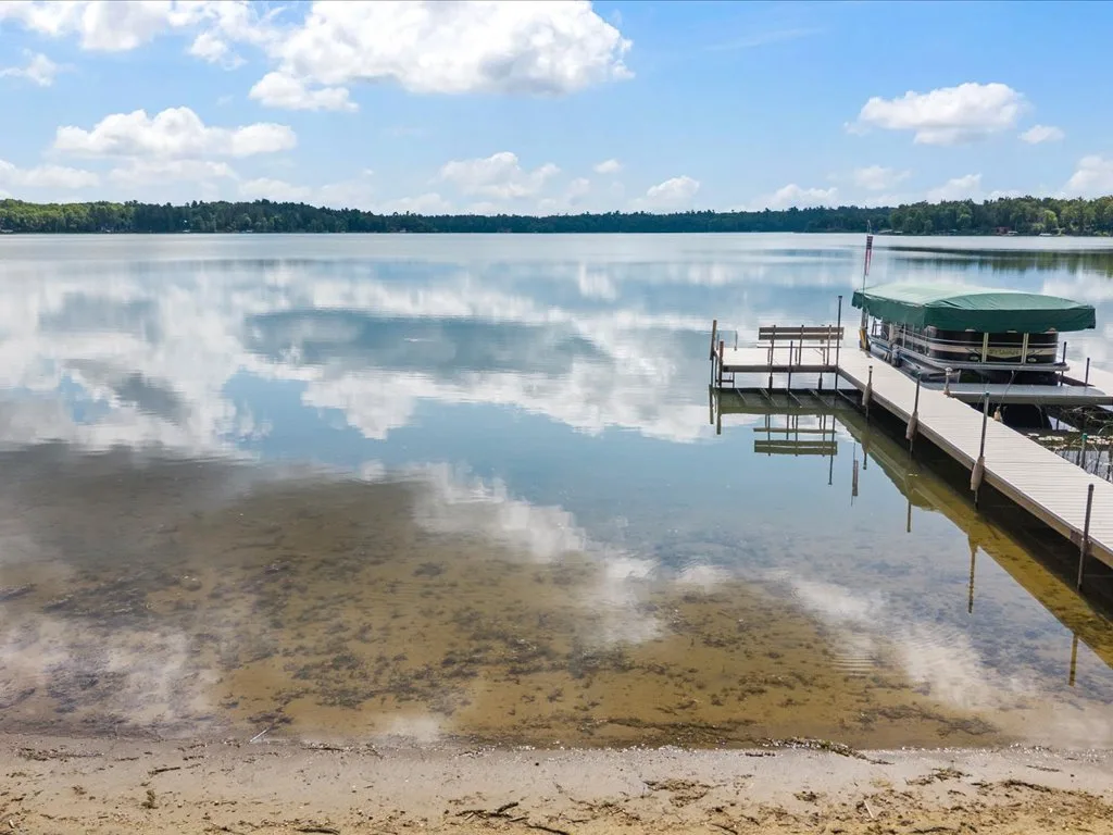 Calm Mitchell Lake water and sandy beach seen from the shoreline