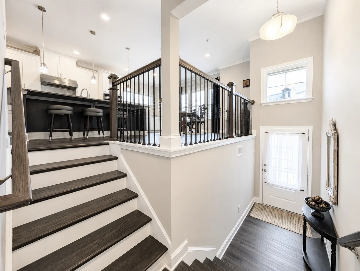 Entry foyer with staircase and black metal balusters
