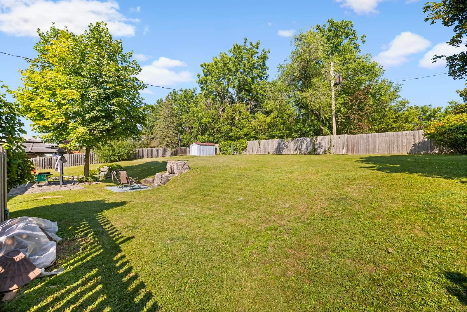 Spacious backyard with pond feature and perimeter fencing