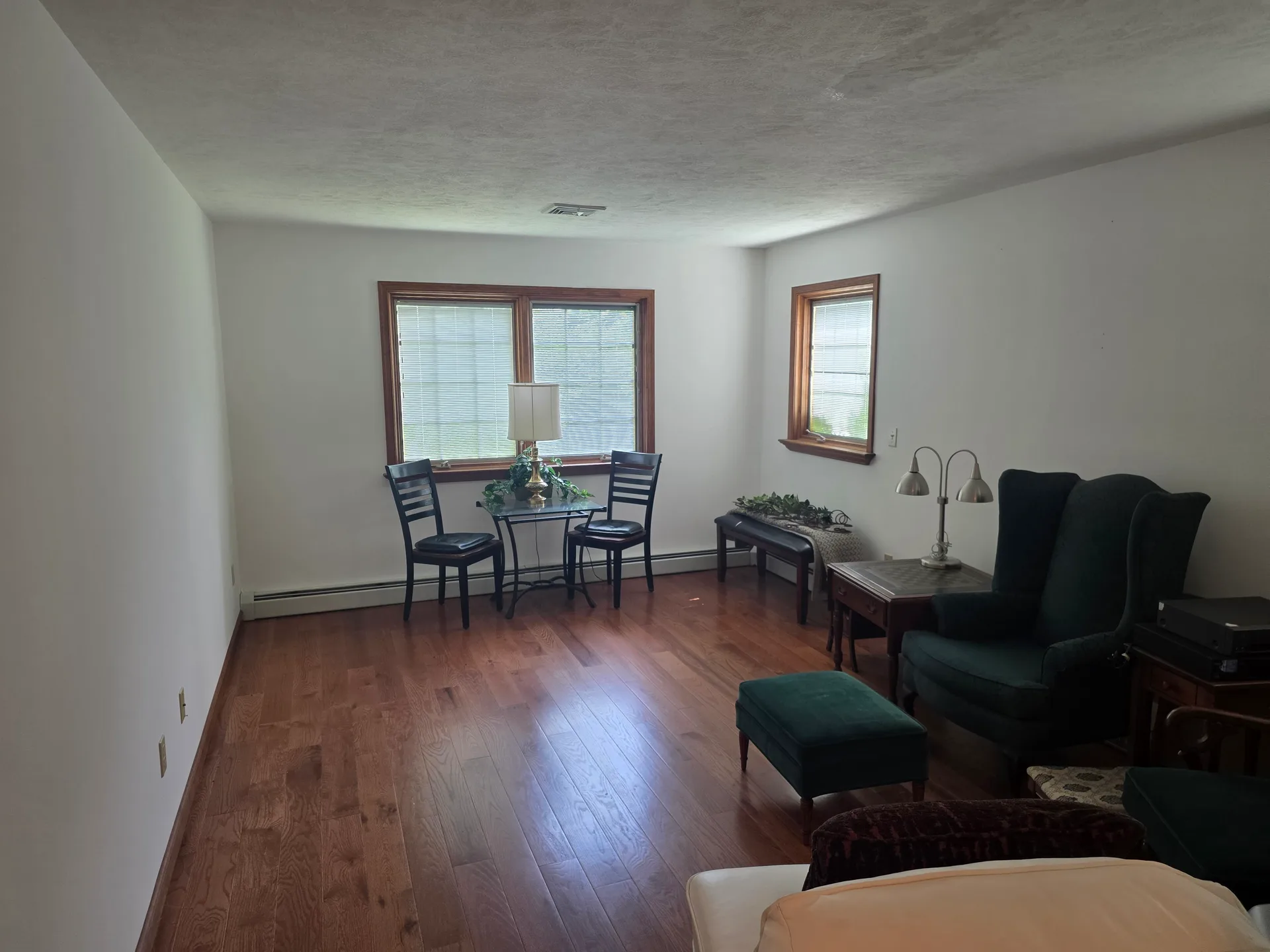 Spacious living room with ranch-style layout and wood window trim