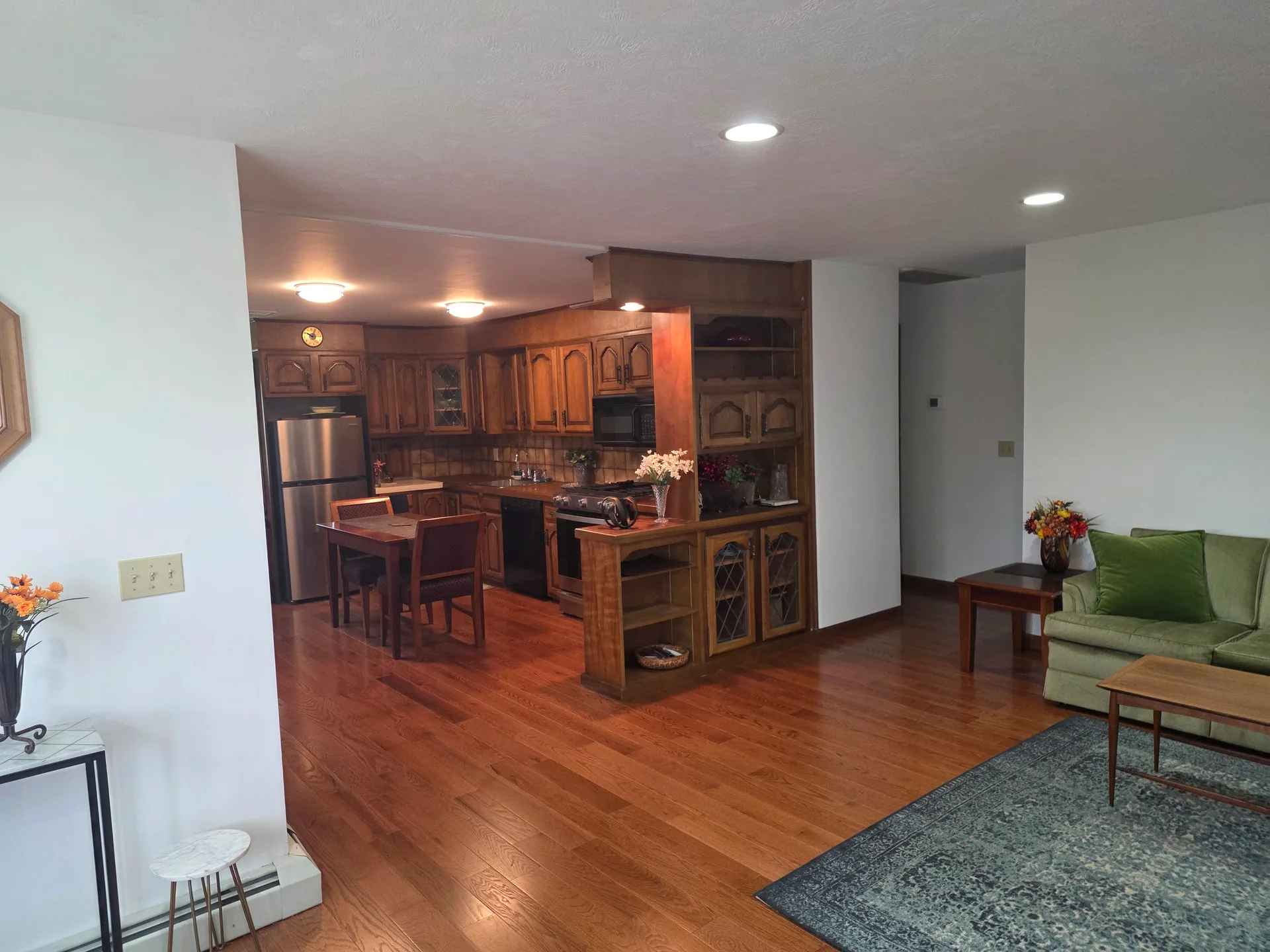 Wide-angle view of open-concept kitchen and living area