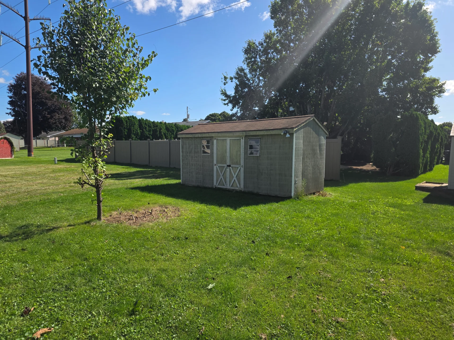 Level yard with a storage shed