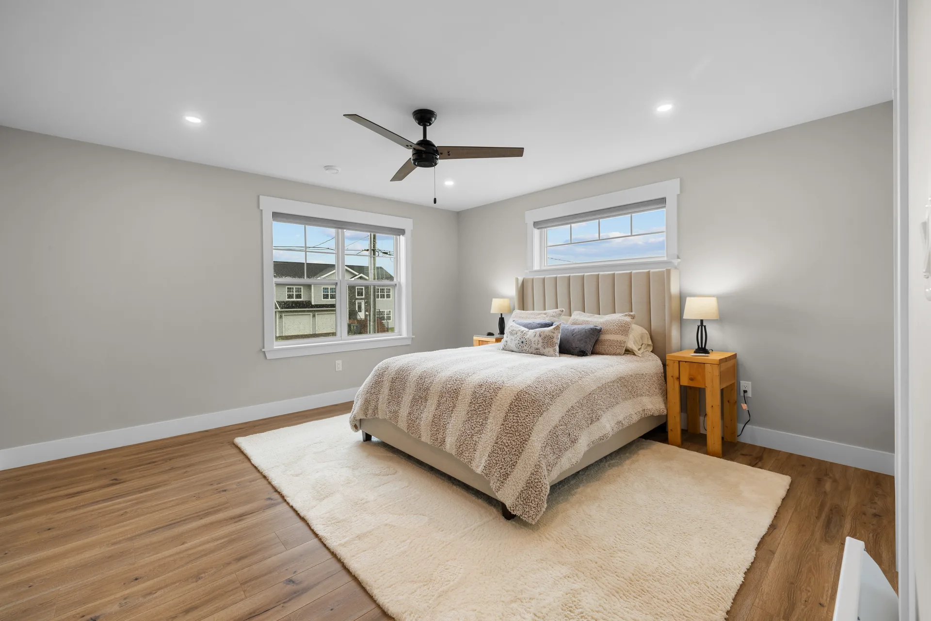 Primary bedroom with neutral decor and natural daylight