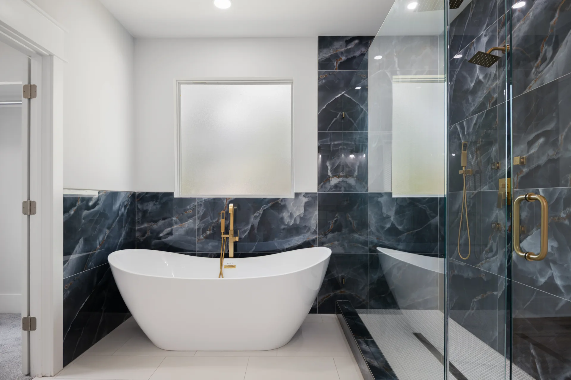 Freestanding soaking tub with dramatic tile wall