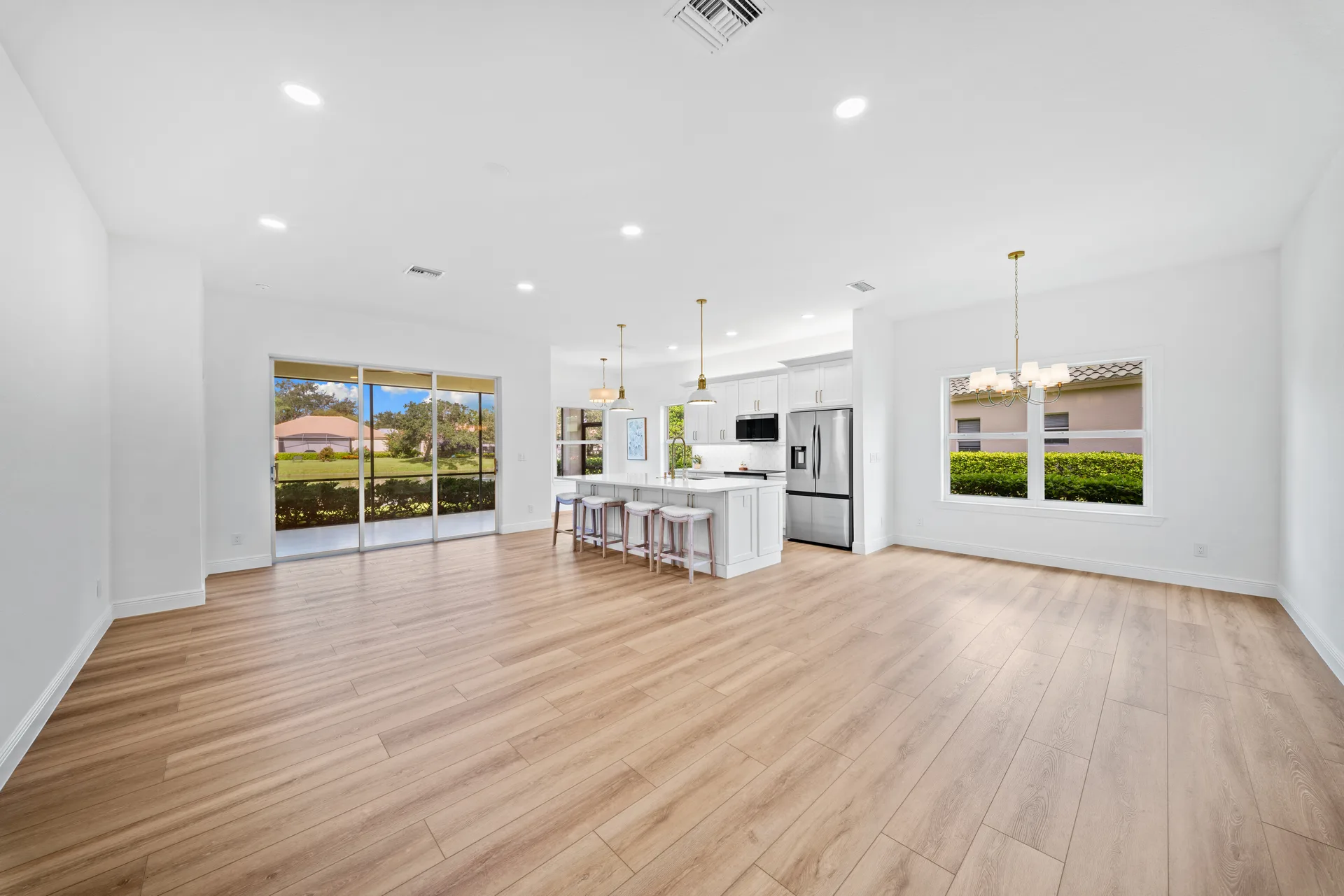 Open-concept kitchen and living area with pendant lights