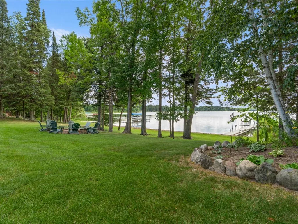 Woodland yard with expansive lawn and a Mitchell Lake view