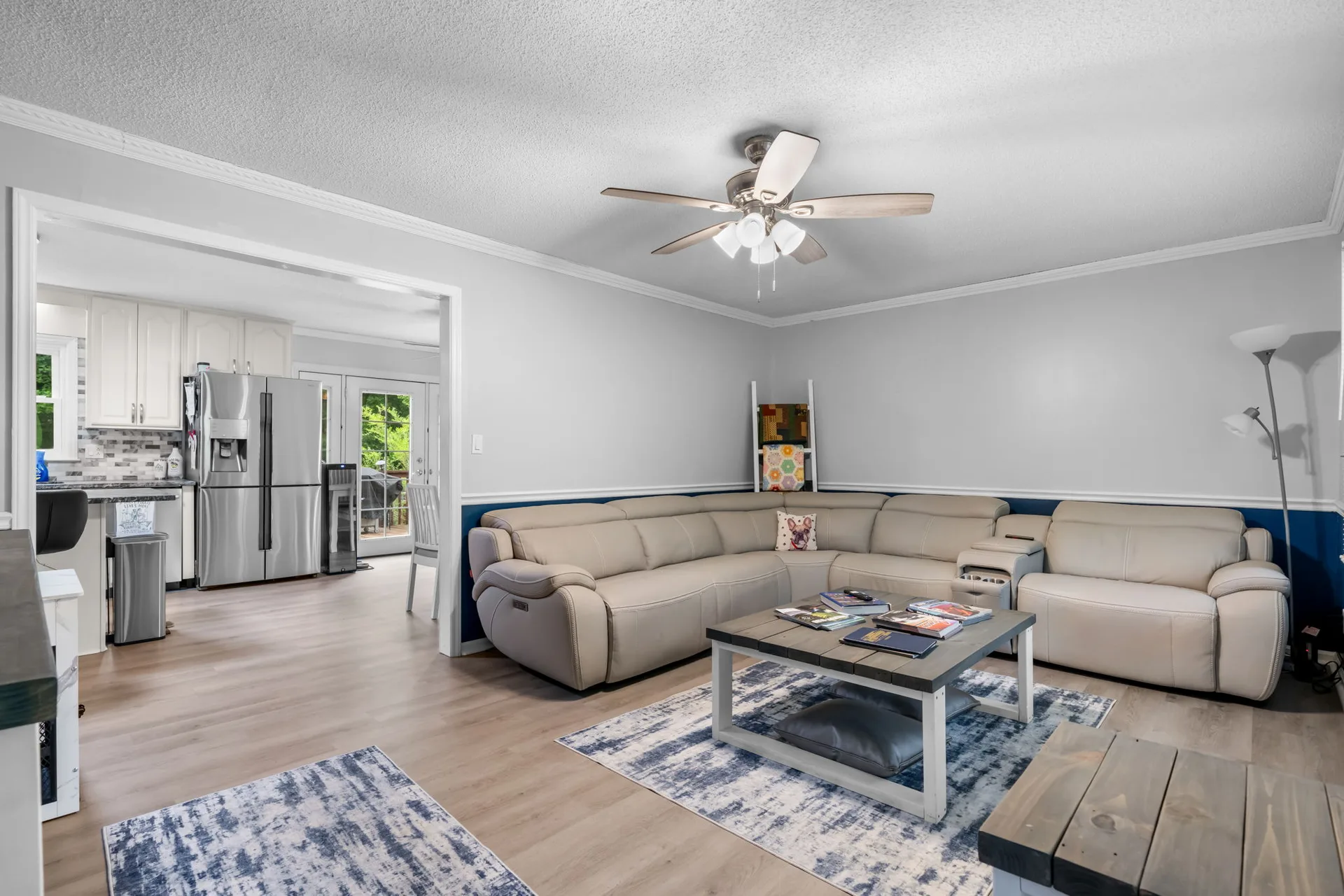 Family room looking into the kitchen with stainless steel appliances visible beyond