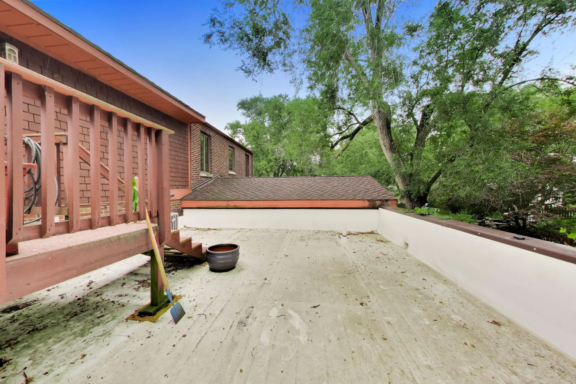 Flat-roof patio beside the raised deck