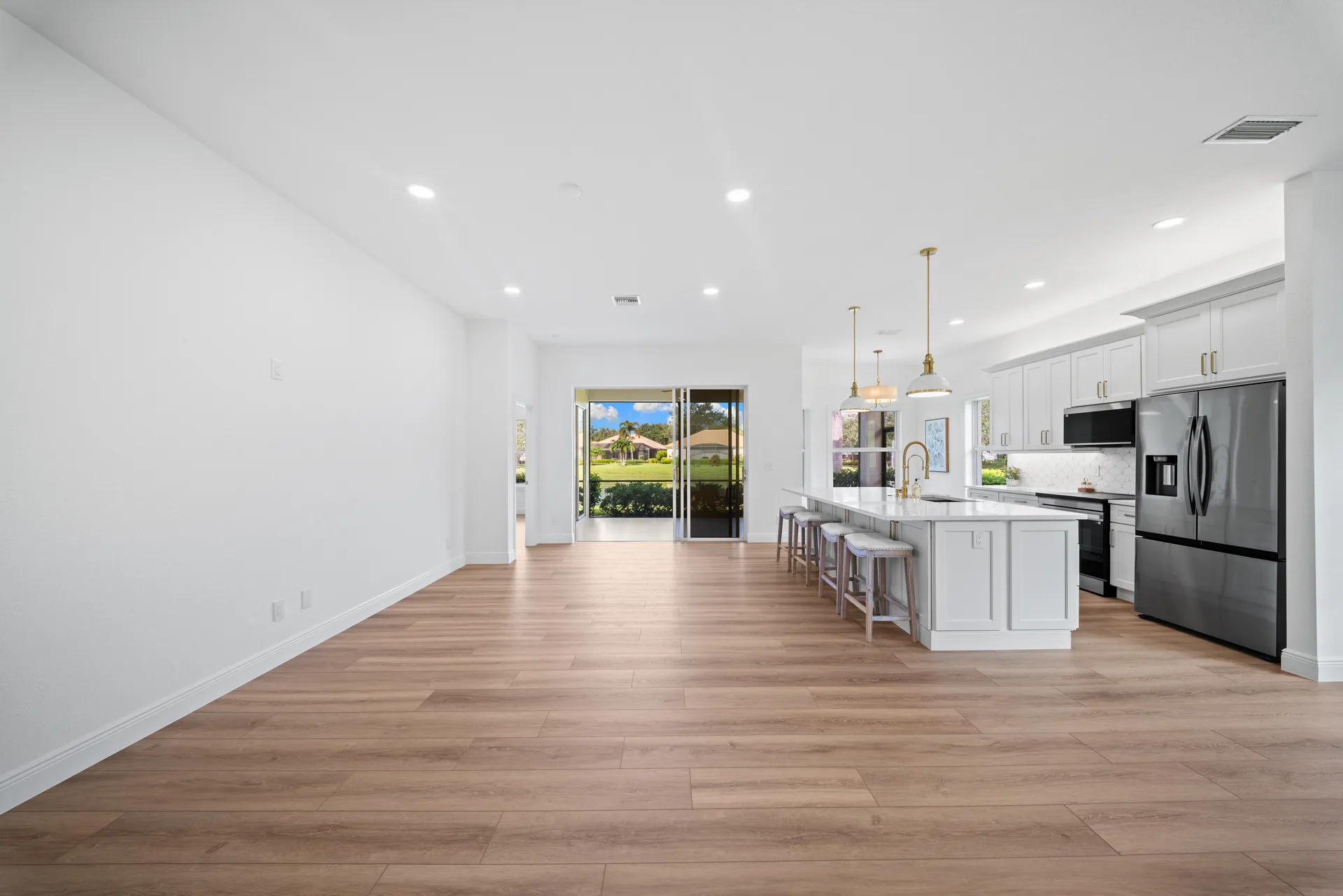 Living area toward kitchen and sliding glass doors