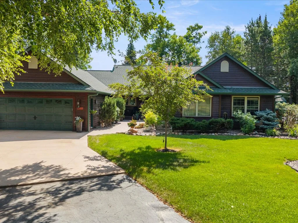 Craftsman-inspired front view with green trim and mature landscaping