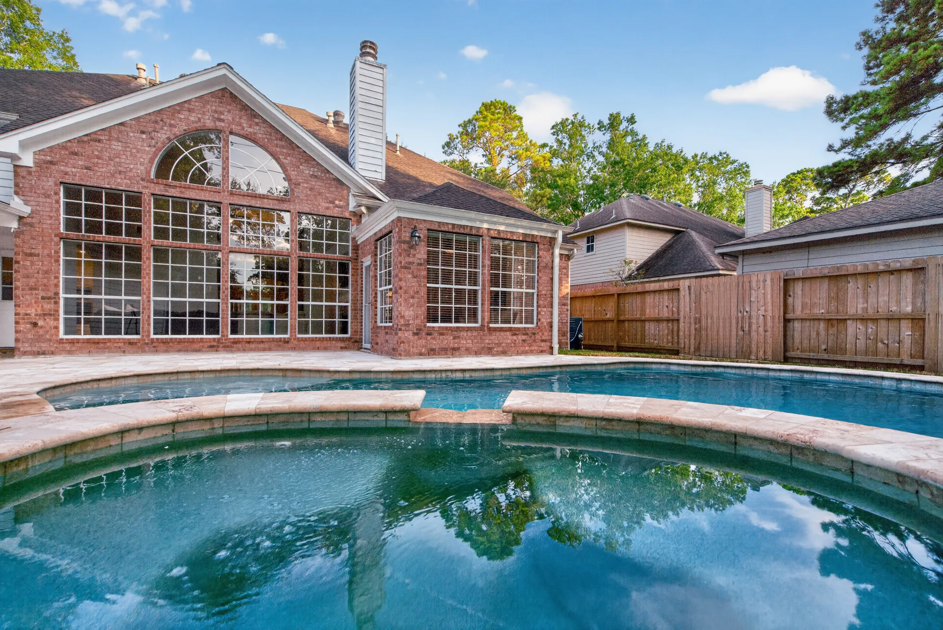 Close view of the pool with heated spa and stone coping