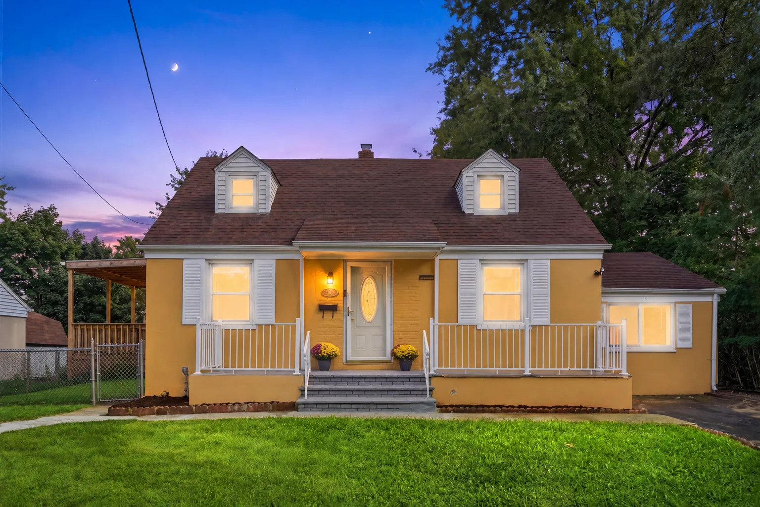 50 Heather Ln at dusk with porch lights glowing and interior lights on