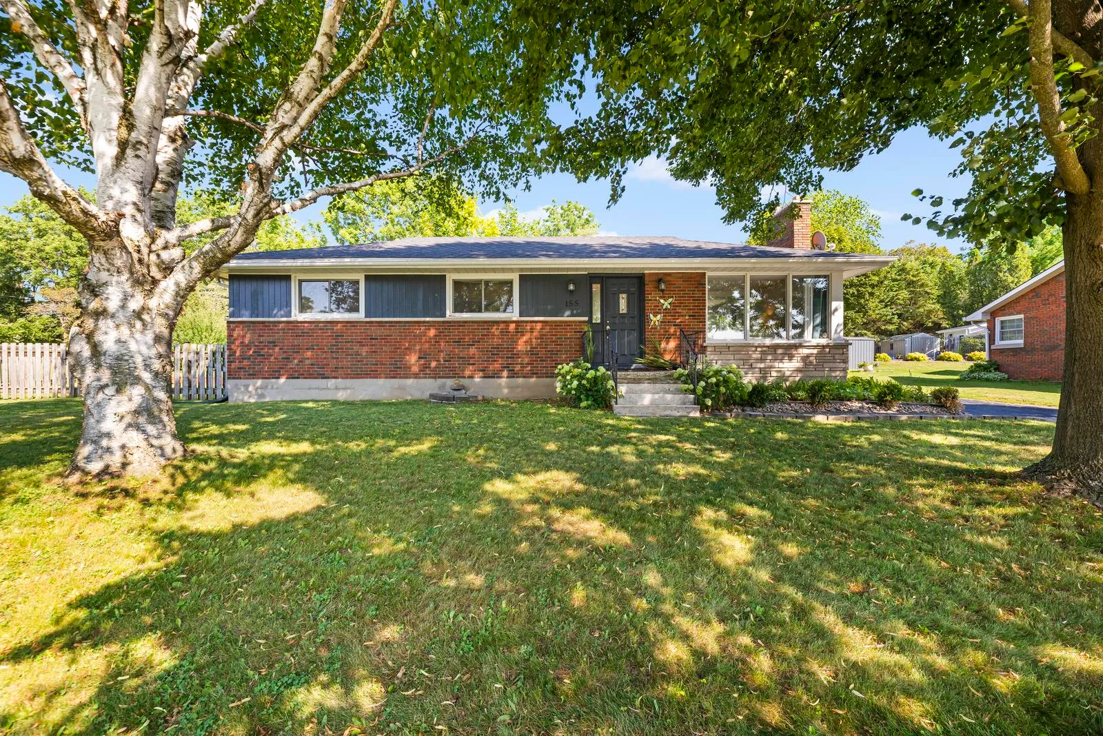 Front exterior of the brick ranch home at 155 Cromwell St. on a quiet, tree-lined street in Campbellford