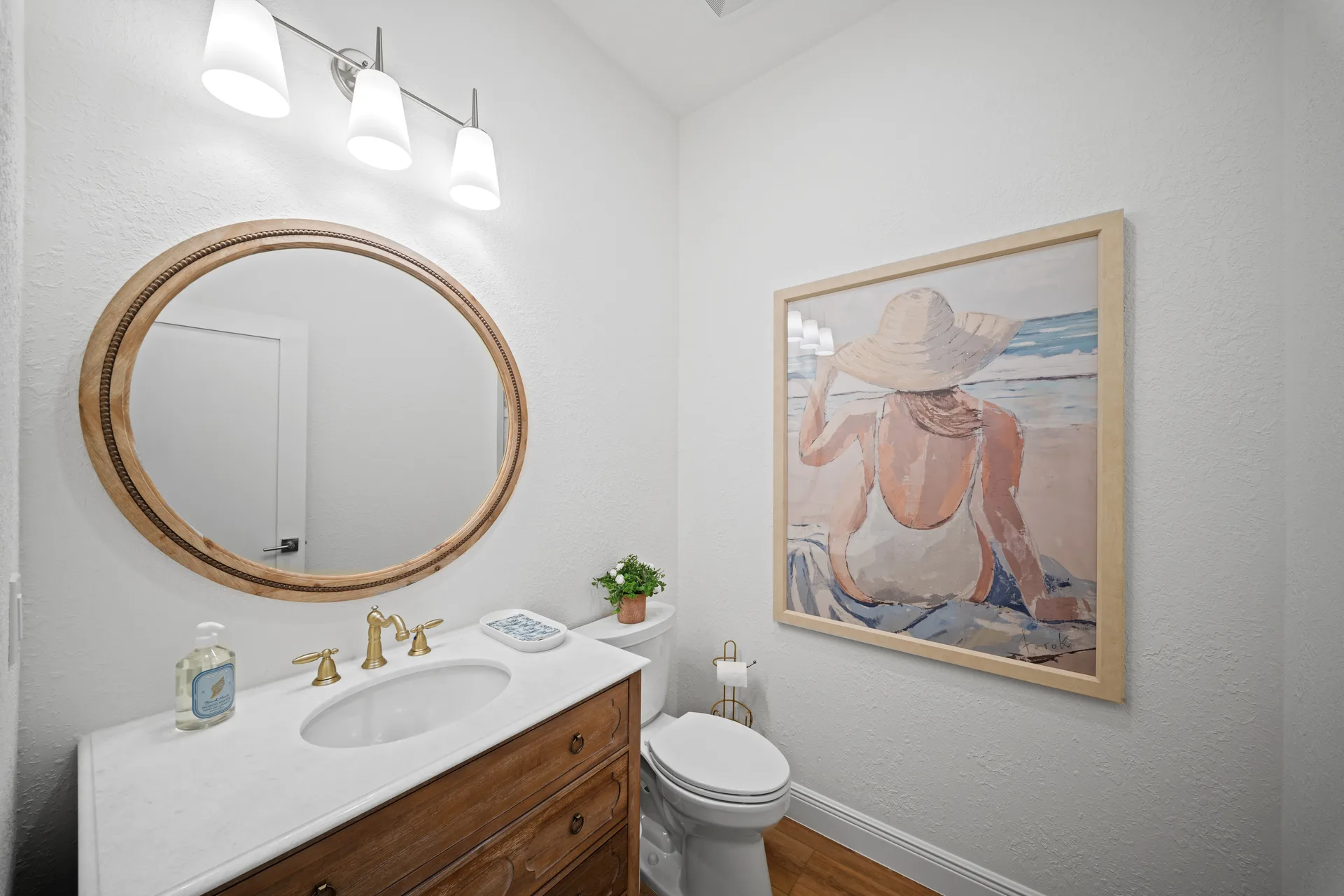 Powder room with wood vanity at 878 Vistana Circle Naples Florida