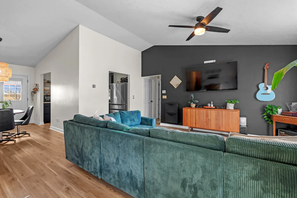 Contemporary vaulted living room with a dark accent wall