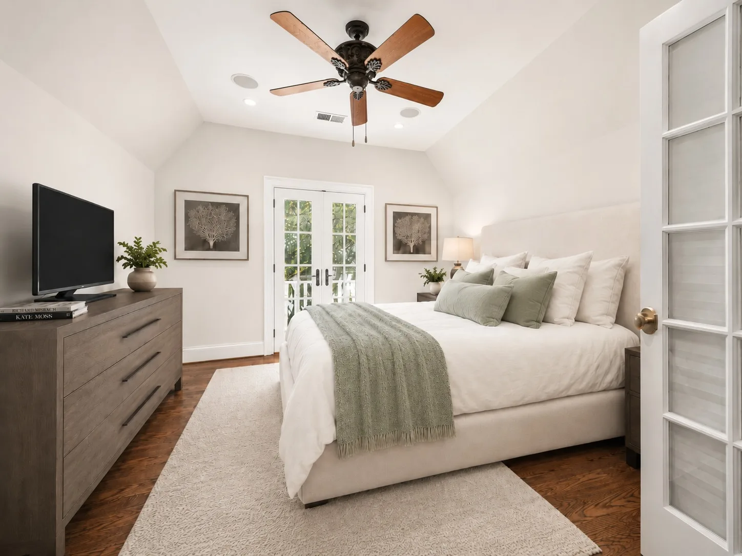 Master bedroom with balcony access and vaulted ceiling