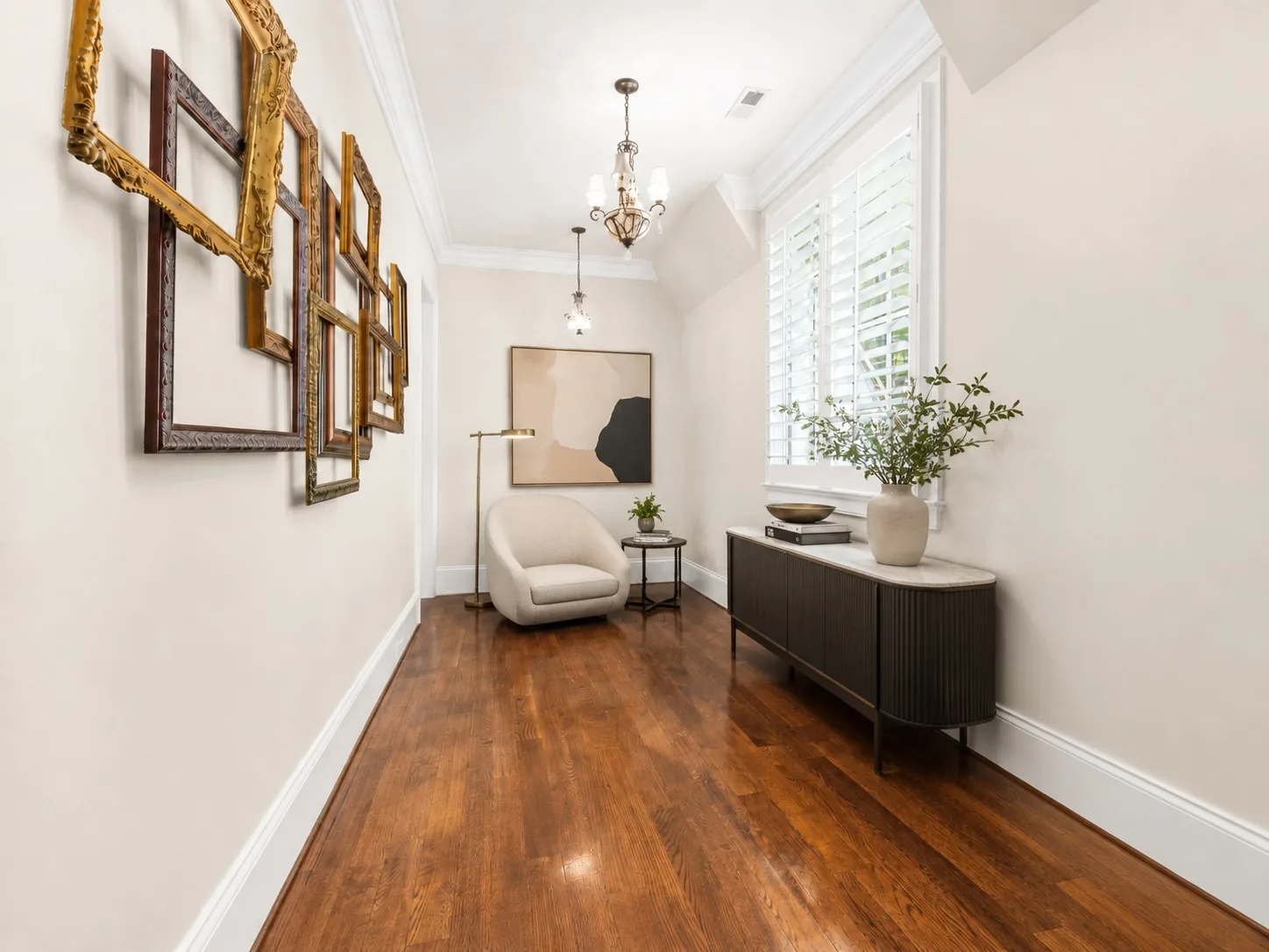 Hallway sitting area with crown molding
