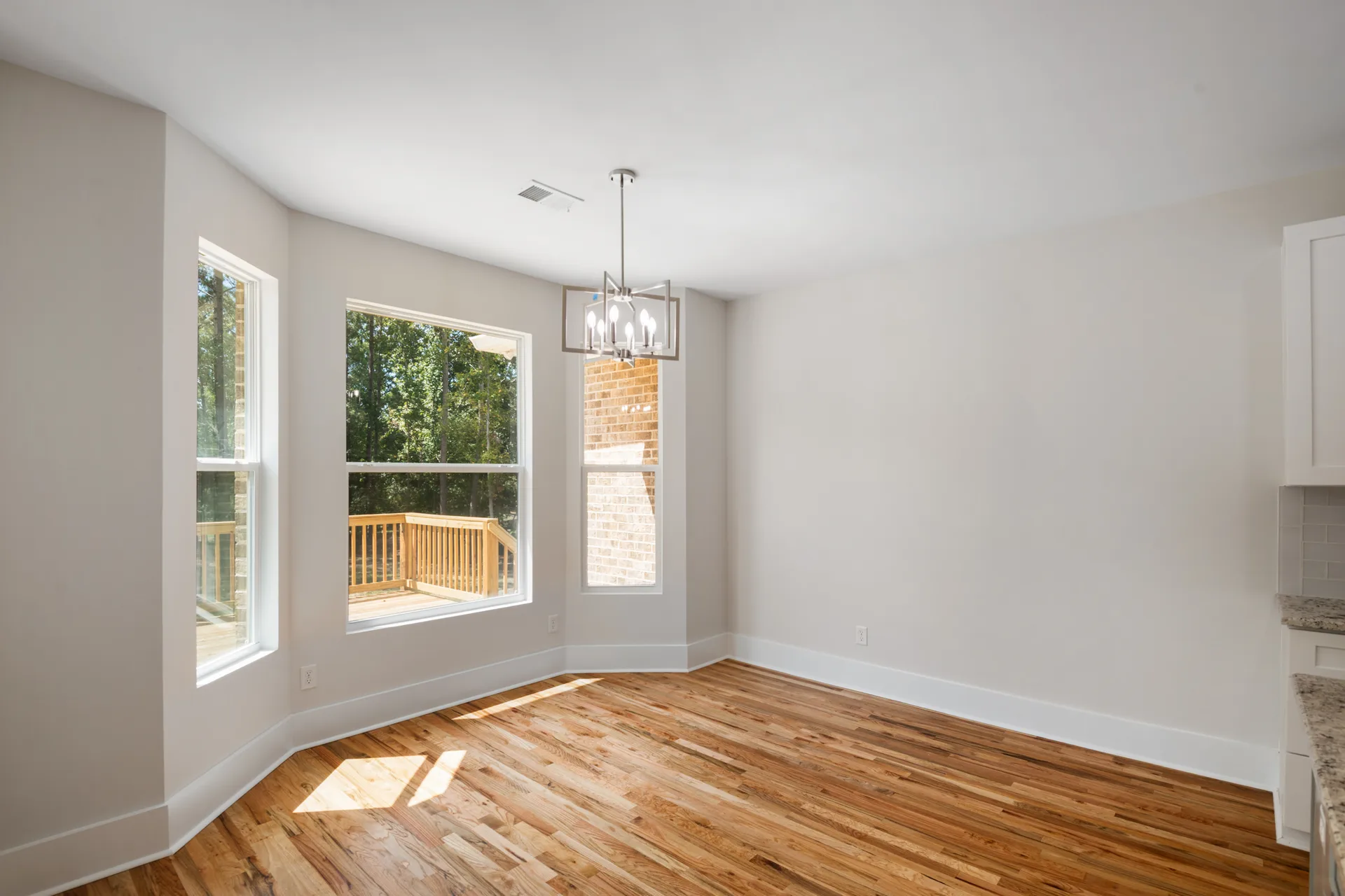 Breakfast area with a bay window and warm morning light