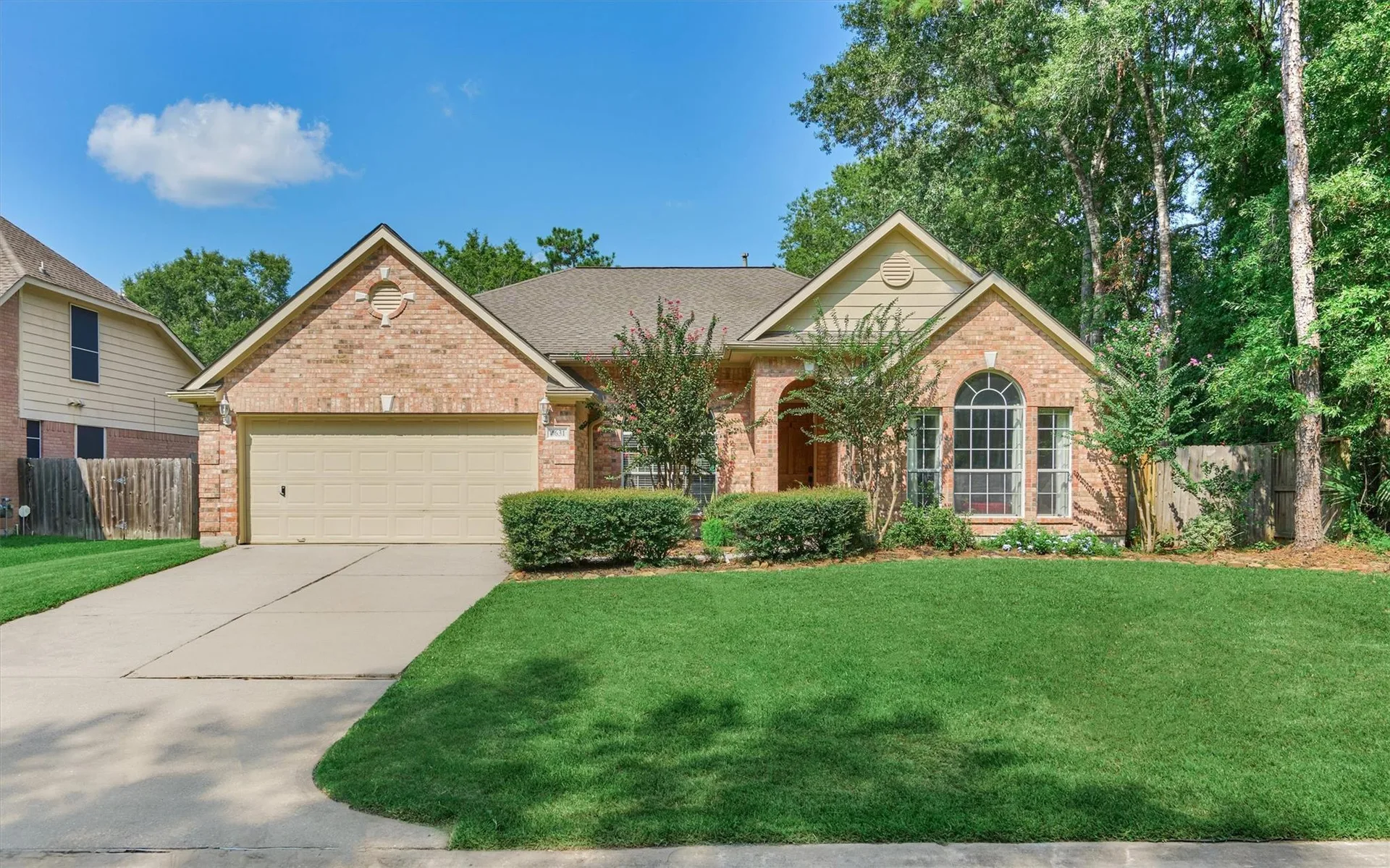 Front exterior of 4631 Windy Gorge Drive, a single-story brick home with mature trees