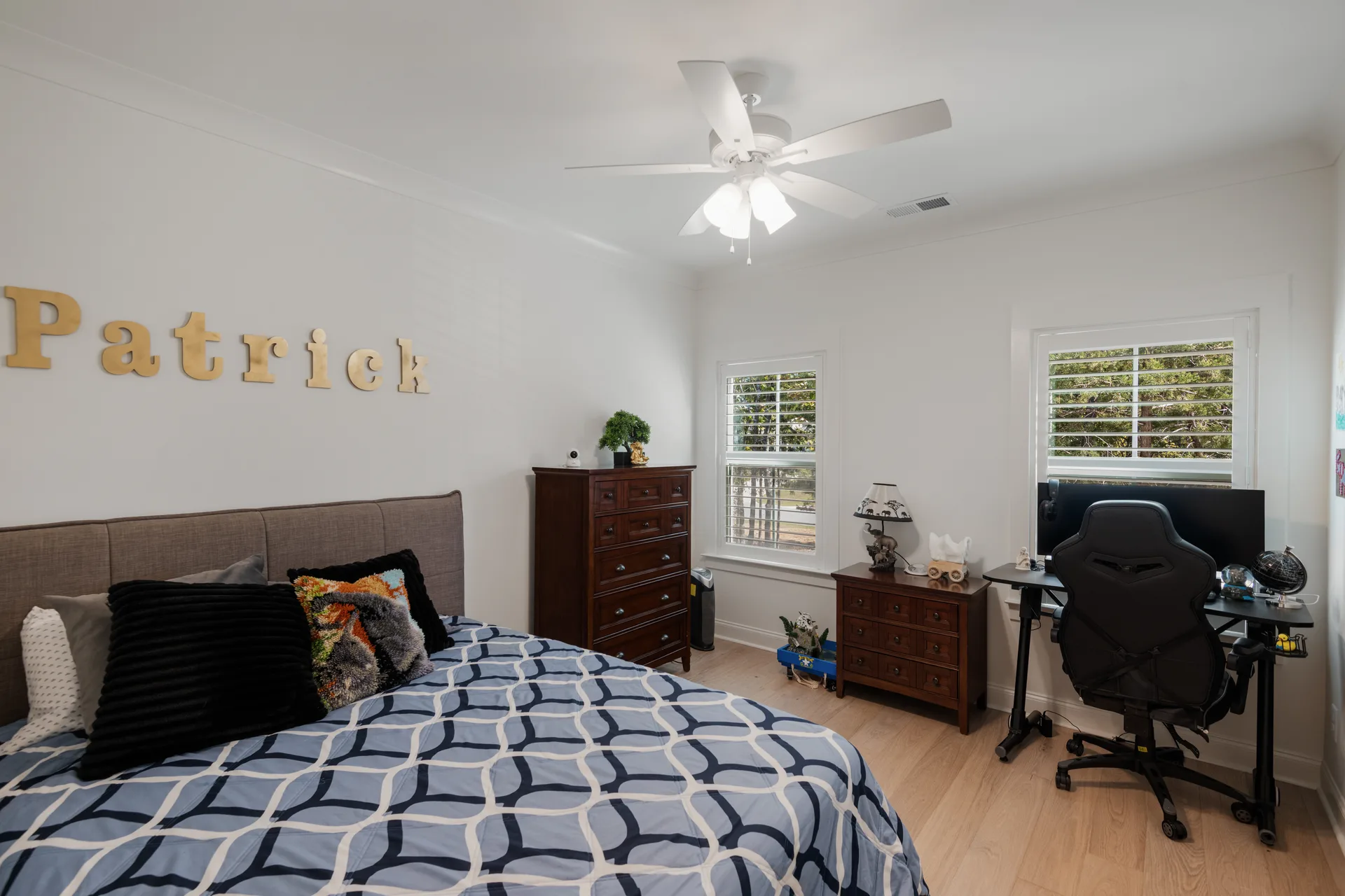 An upstairs bedroom with a desk setup