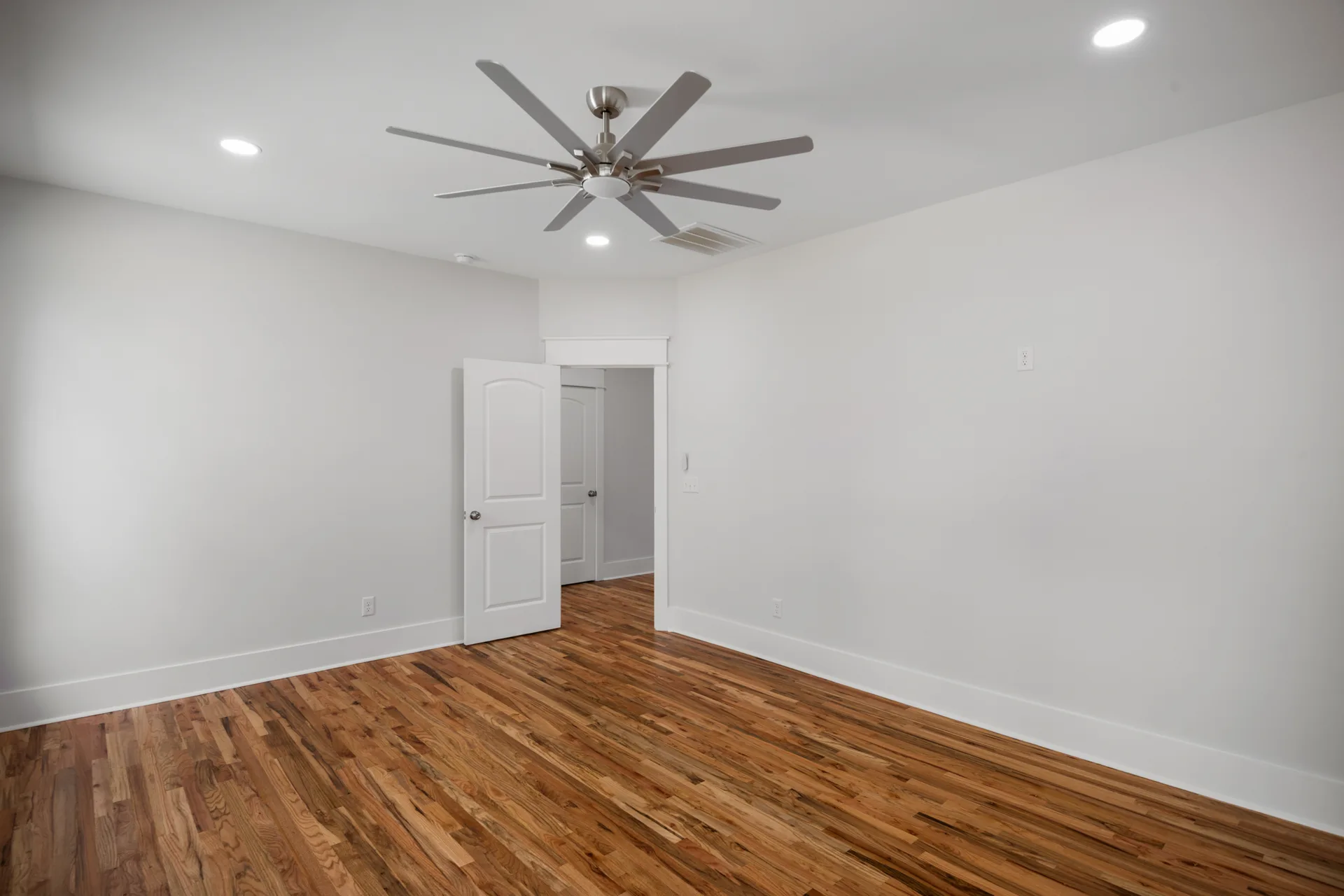 Bedroom with hardwood floors and recessed lighting