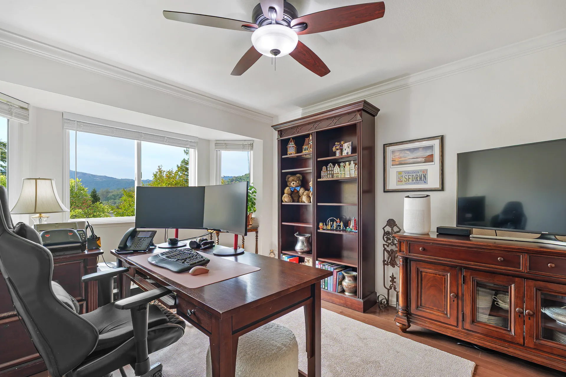 Home office bedroom with bay window, hill views and crown molding