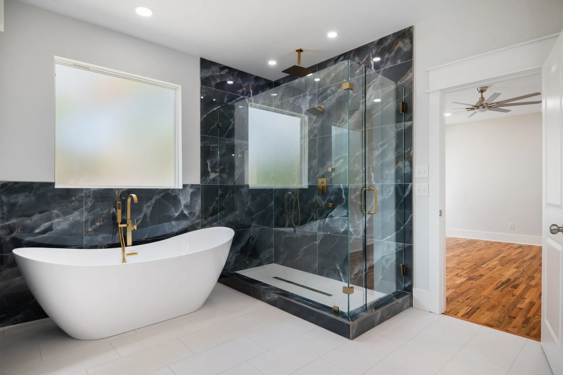 Primary bath with freestanding tub and glass spa shower