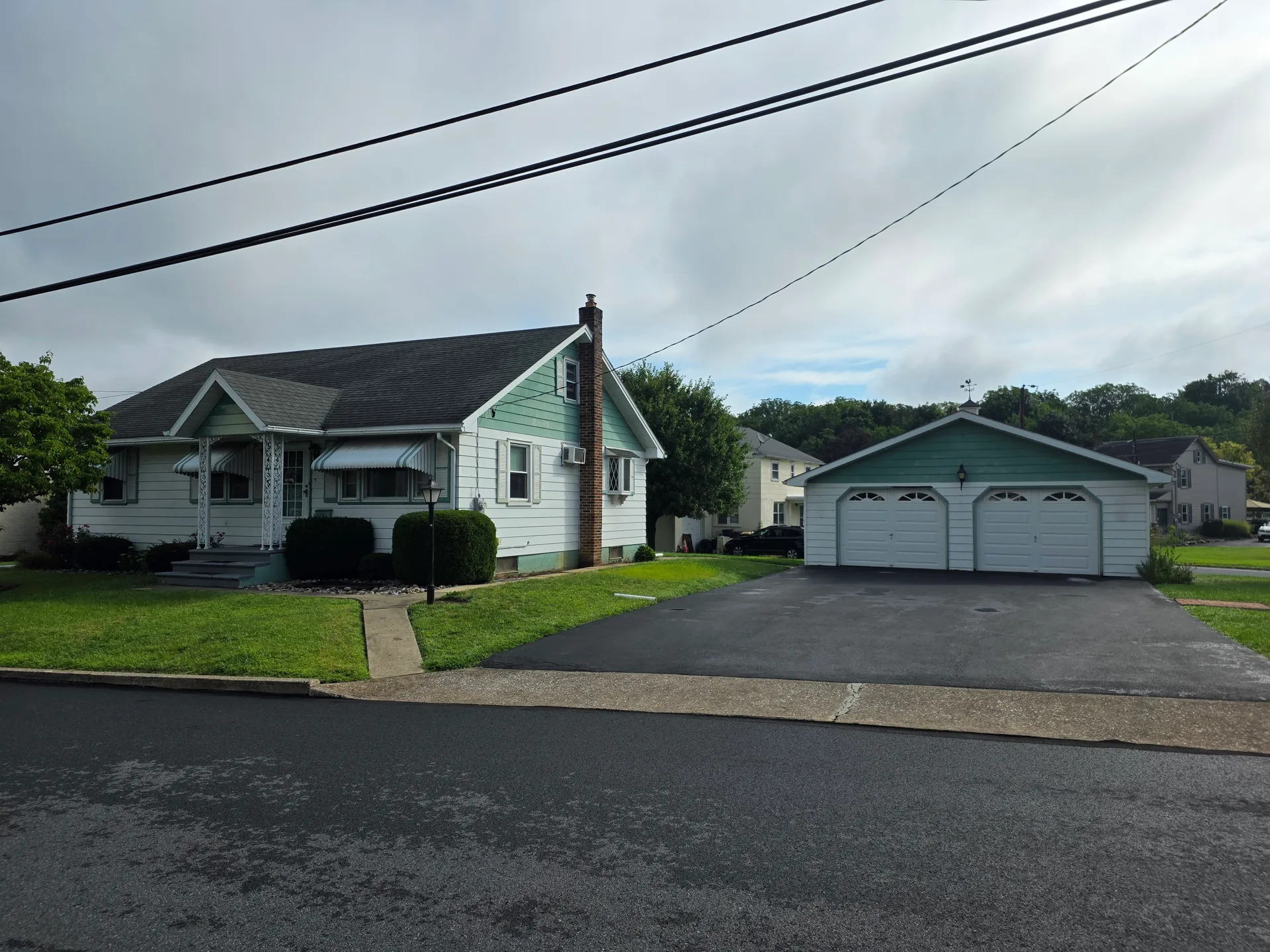 Street view of 4365 Spruce St showing the ranch home and detached garage